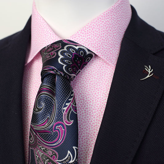 a pink floral printed mens shirt with a charcoal jacket over the top and a navy paisley mens tie